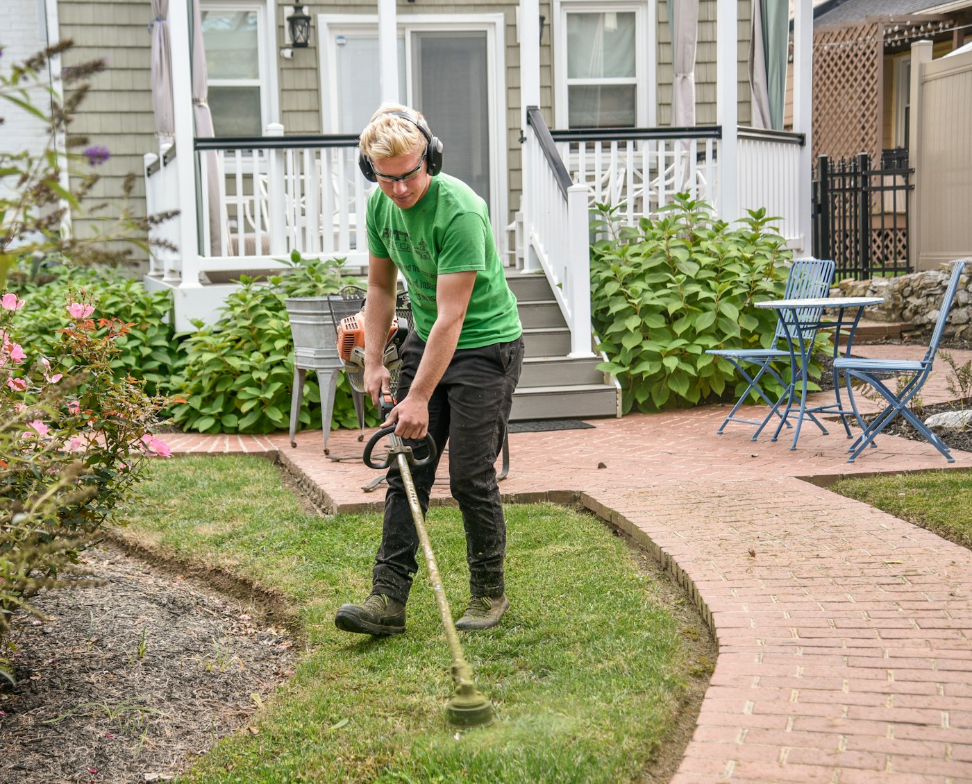 Gardener with a shovel preparing a garden bed